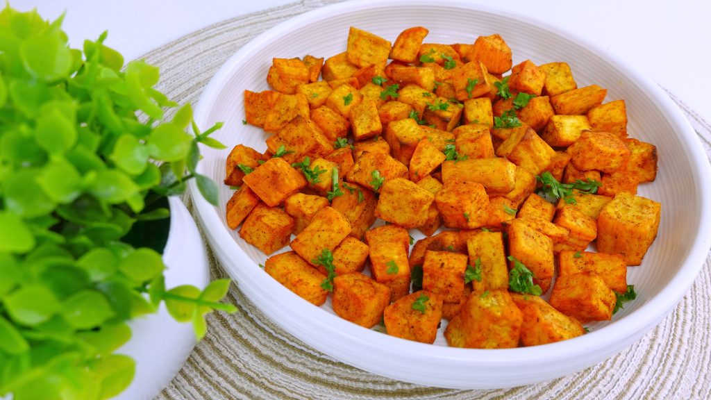 A plate of ready-to-eat fried sweet potato cubes, perfectly crisp.