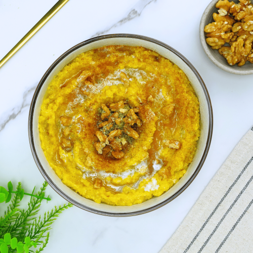 A bowl of healthy breakfast pumpkin pie quinoa garnished with cinnamon.