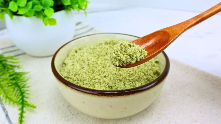 Homemade pumpkin seed flour in a measuring spoon close-up.