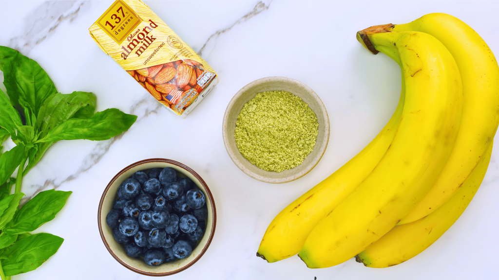 Ingredients for blueberry basil smoothie on a table