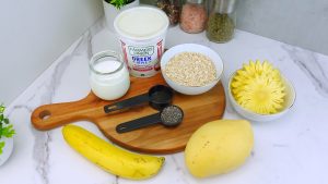 Ingredients for coconut overnight oats neatly arranged on a counter.