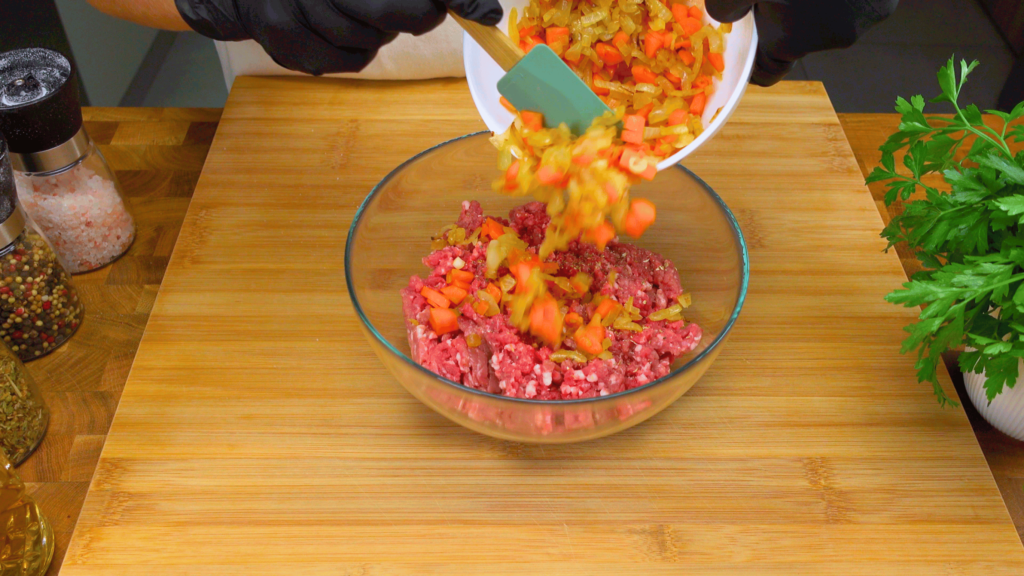 Combining minced meat with vegetables for filling