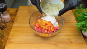 Mixing vegetables, minced meat, and rice for stuffing