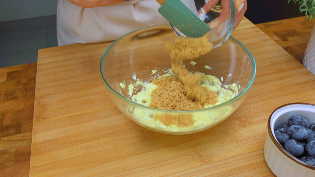 Adding sugar to whipped butter.