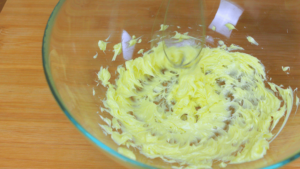 Whipping butter in a glass bowl.