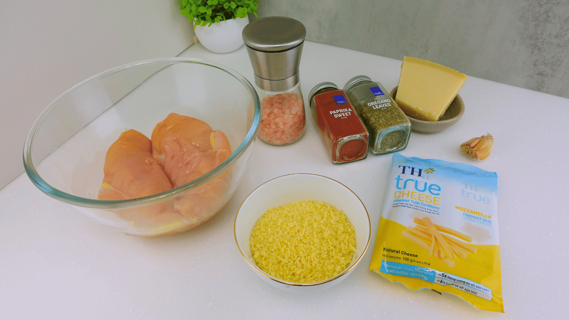 Ingredients for Chicken Alfredo - chicken breasts on a wooden cutting board.