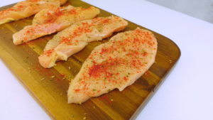 Chicken breasts seasoned with paprika and Mediterranean herbs.