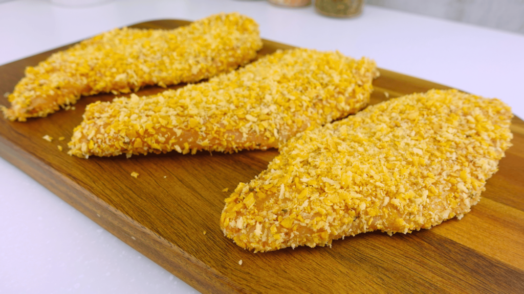 Close-up of chicken breasts breaded with cornflakes and panko.