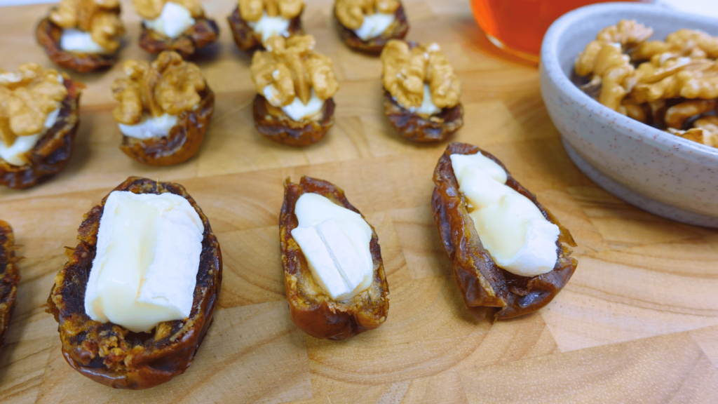 Close-up of stuffed dates with walnuts and Brie cheese.