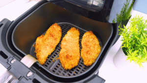 Cooked chicken breasts in an air fryer.