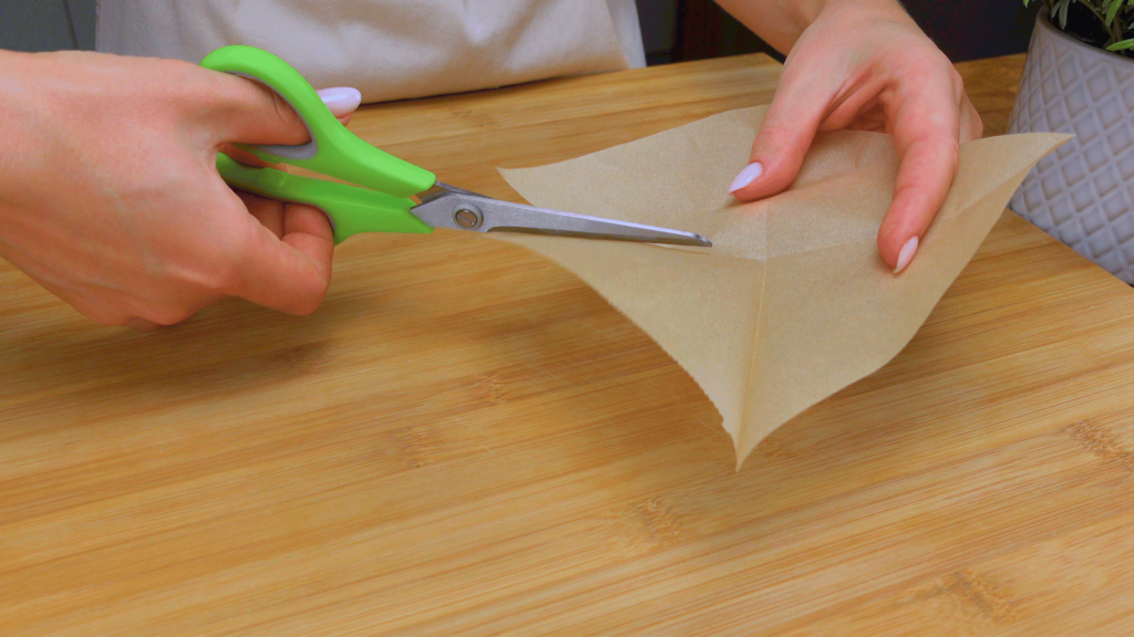 Cutting parchment paper for muffin liners.