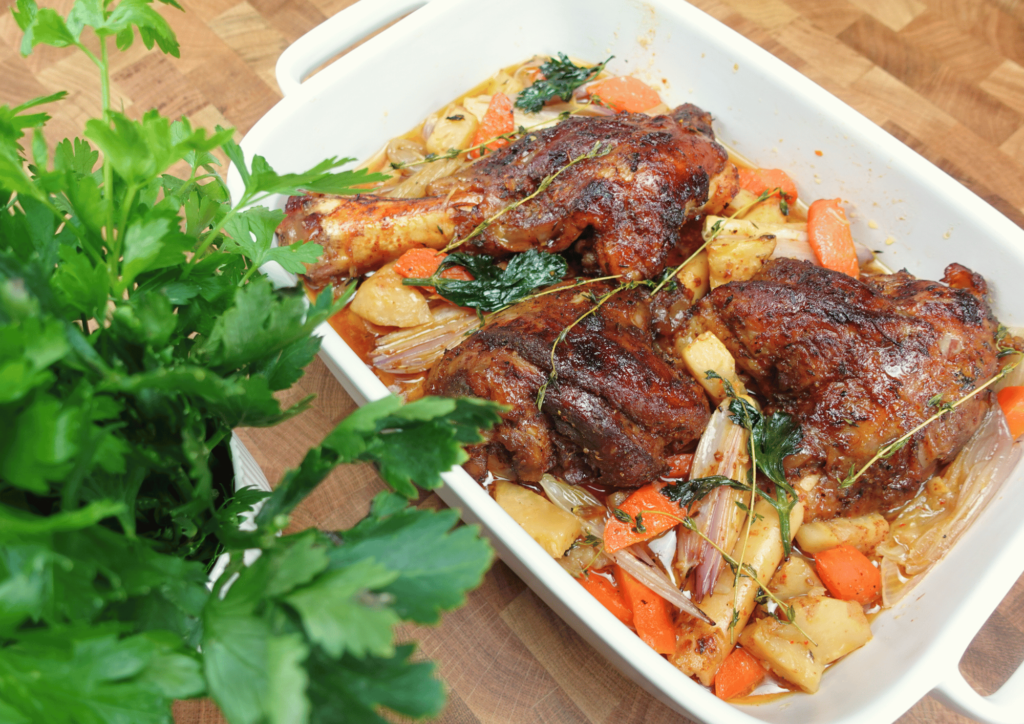 slow cooker lamb shank on a plate with juicy meat, surrounded by a rich, savory sauce.