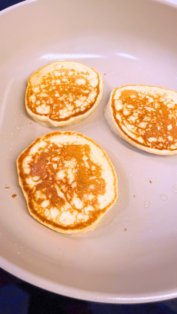 Cooking banana pancakes on a frying pan.