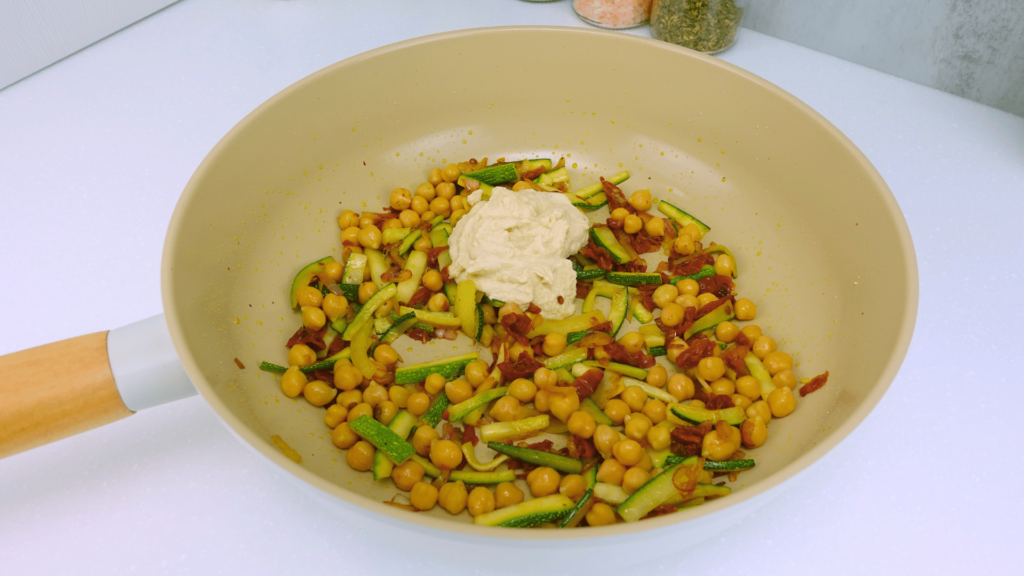 Blending cashew cream sauce for a creamy high-protein pasta.