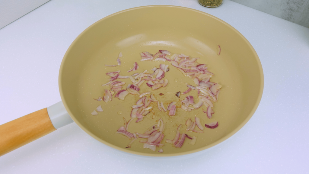 Red onion sautéing in a pan for the creamy Marry Me Pasta recipe.