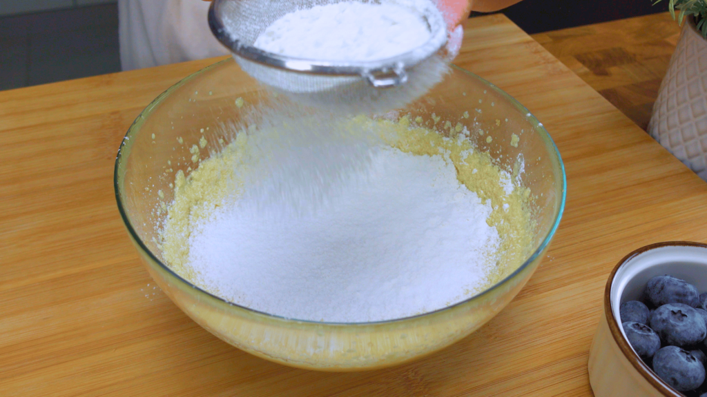Sifting flour with baking powder.