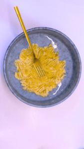 Mashing ripe bananas with a fork in a bowl.