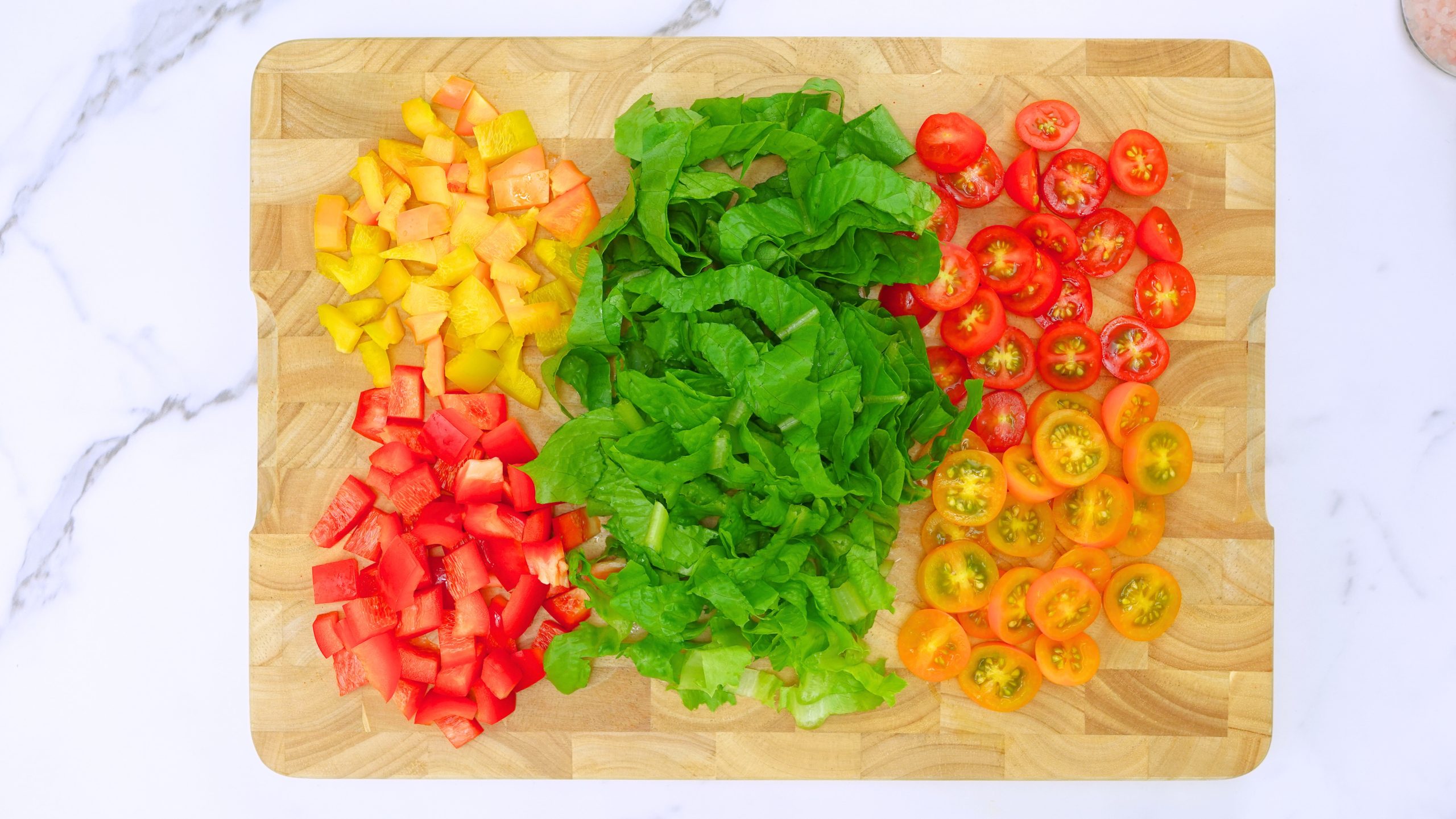 vegetables and greens for taco salad chopped on cutting board scaled