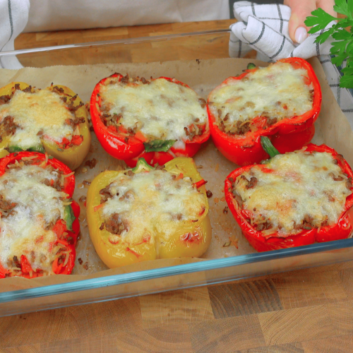 Perfectly baked bell pepper stuffed with tender chicken and sweet mango pieces, served on a plate.