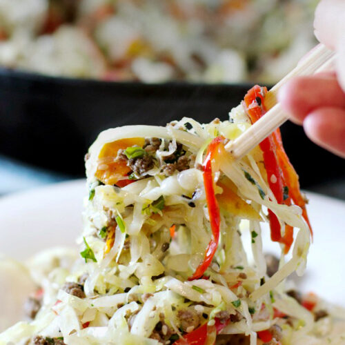 Asian Skillet Slaw In Bowl Eated by Chineese Chopsticks