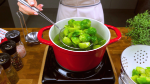 Brussels sprouts boiling in a pot of water.