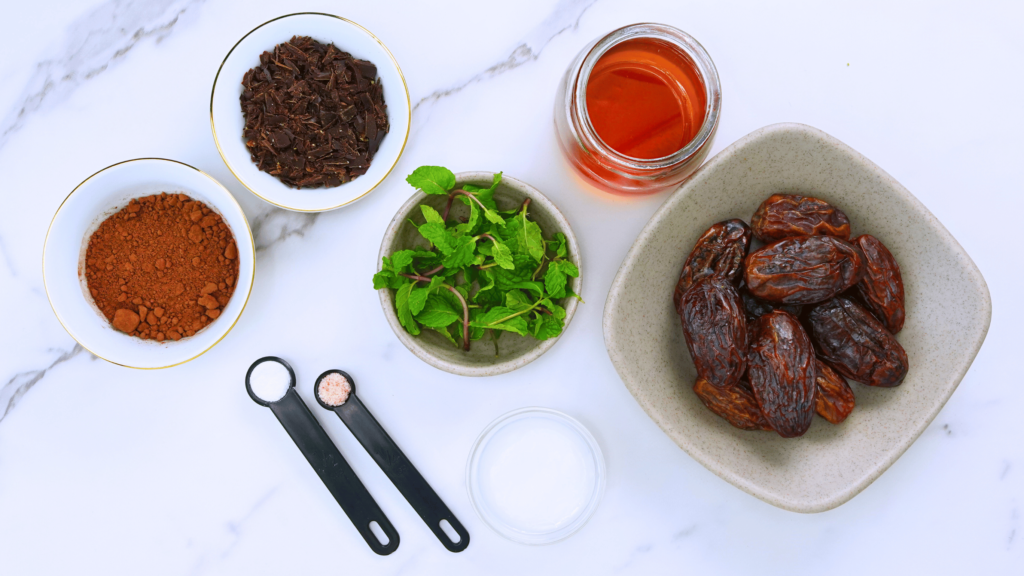 Ingredients for making cacao nibs truffles arranged on a white surface.