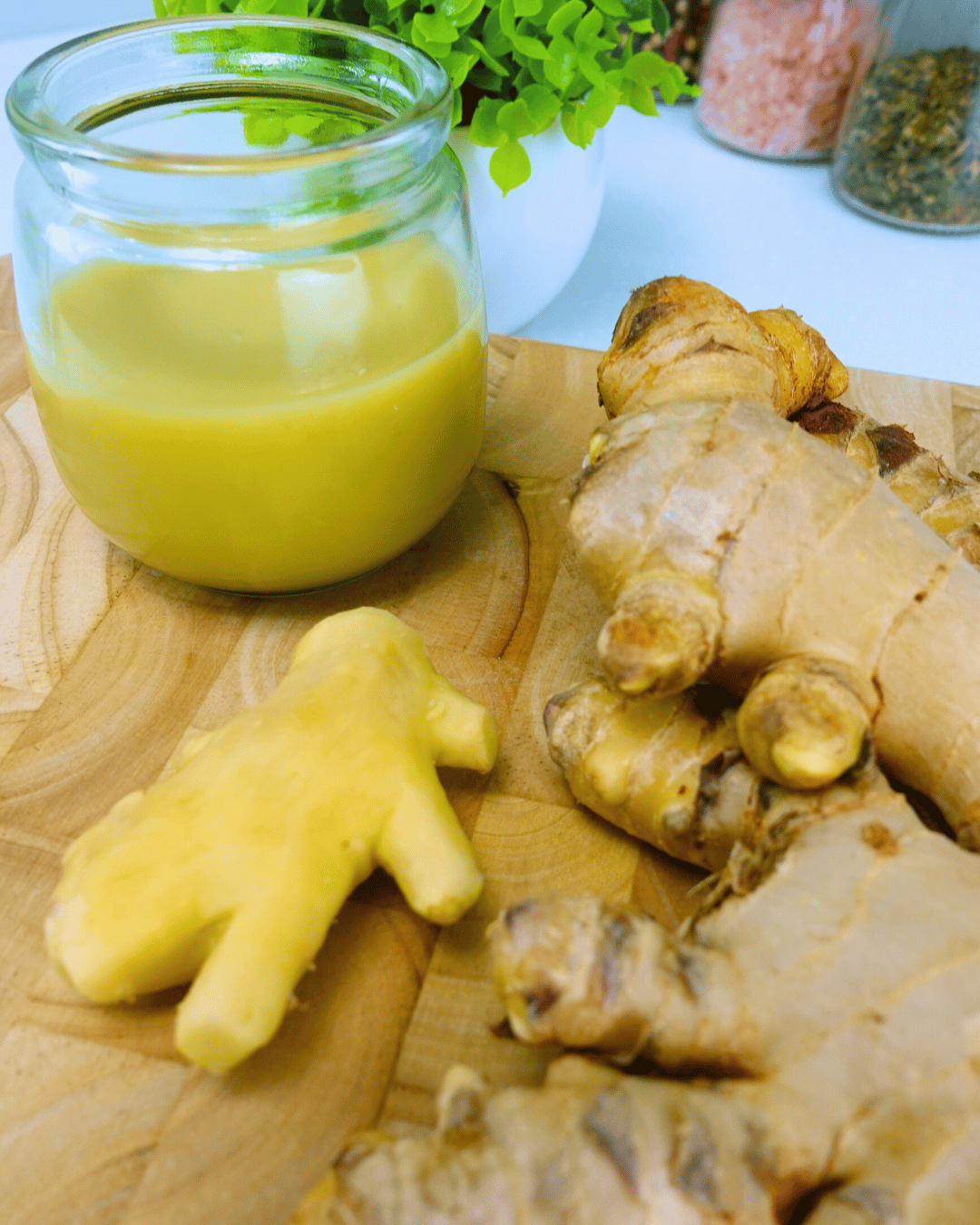 ginger juice in jar with ginger on board