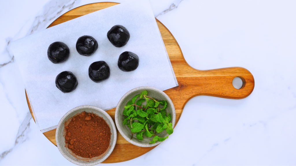 Rolled truffle balls ready to be coated in cocoa powder.