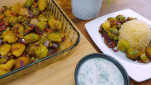 Serving Brussels sprouts and pecans with rice or quinoa on a plate.