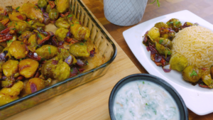 Serving Longhorn Brussels Sprout Recipe and pecans with rice on a plate.